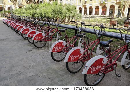 Barcelona Spain - February 25 2017: A row of bicycles in the exchange program Bicing bike community in Barcelona People can rent bicycles for short trips reducing traffic and pollution.