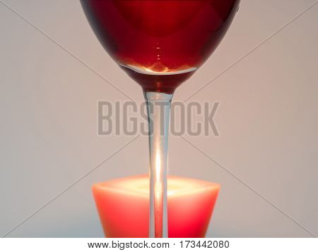 Fire candle through the leg with a glass of red wine