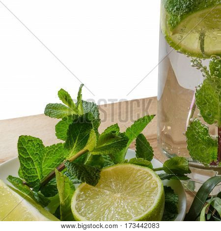 Non-alcoholic mojito with a slice of lime mint and estragon in a glass with gas bubbles