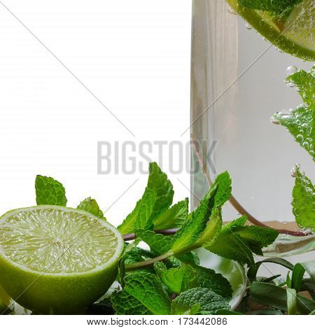 cocktail mojito with a slice of lime mint and estragon in a glass with gas sparkles