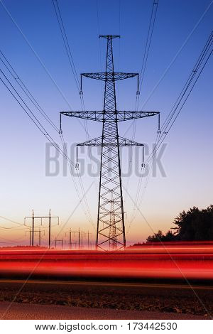 Pylon and transmission power line in sunset