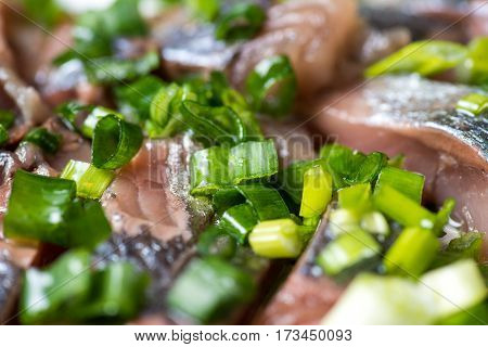 Sliced herring with onions on a cutting board