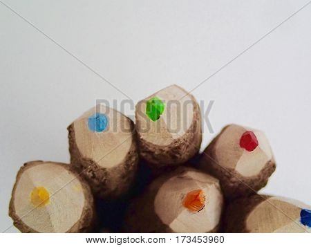 Rustic colored pencils in a pile on a white background.
