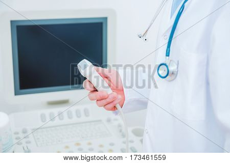 Ultrasonography Testing Concept. Medical Doctor with the Ultrasonography Device in a Hand.
