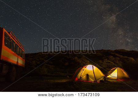 Milky Way in the night sky above the tourist campground. Brookvalley Spokoyny at the foot of outer north-eastern slope of caldera volcano Gorely.