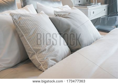 Close up gray striped pillows on bed