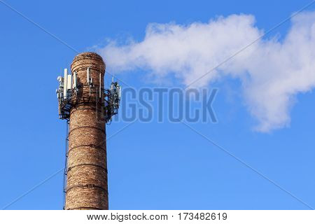 Smoke from pipe on a background of clear sky