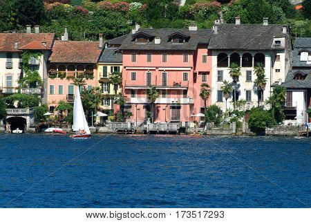 People Sailing On A Sailboat Front Of Orta