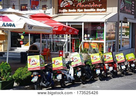HERAKLION, CRETE - SEPTEMBER 19, 2016 - City centre restaurant with delivery bikes parked outside Heraklion Crete Greece Europe, September 19, 2016.