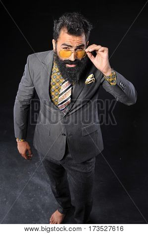 young handsome man wear gray suit on black background