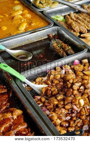 Variety of delicious Malaysian home cooked dishes sold at street market stall in Georgetown, Piang Island, Malaysia