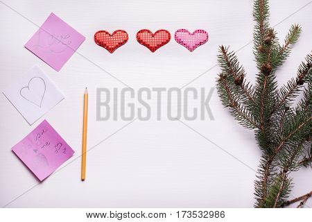 Wooden White Background With A Branch Of Pine And Three Hearts.