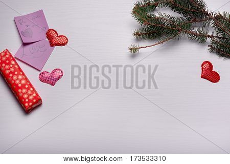 Wooden White Background With A Branch Of Pine And Three Hearts.