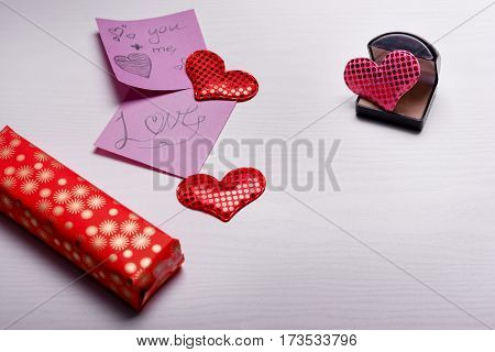 Wooden White Background With A Branch Of Pine And Three Hearts.
