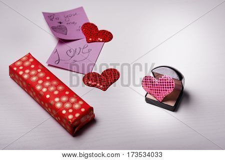 Wooden White Background With A Branch Of Pine And Three Hearts.