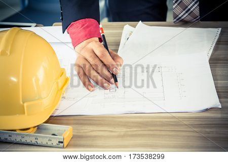 Engineer and architect discuss with about new project in cafe