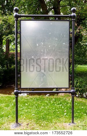 Blank iron billboard for advertising in a park. Metal notice board