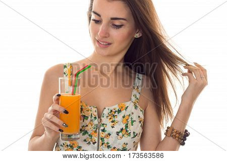 Portrait of a beautiful young girl in Sarafan which lowered her eyes and holds in his hand a glass of juice close-up isolated on white background.