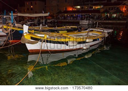 Small wooden fishing boats in marine night