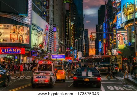 NEW YORK CITY, USA - AUGUST 14, 2016: Buildings and street life on the Times Square - one of the world's most visited tourist attractions, drawing an estimated 50 million visitors annually. Lowlight.