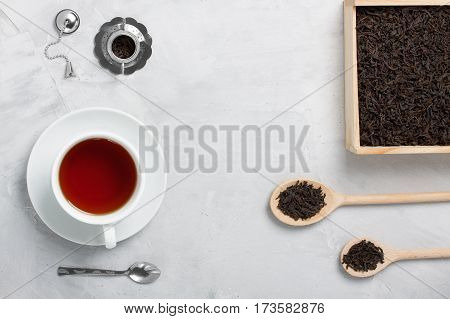 Cup Of Tea Silver Spoon Little Teapot On Concrete Background.