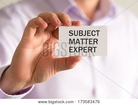 Businessman Holding A Card With Subject Matter Expert Message