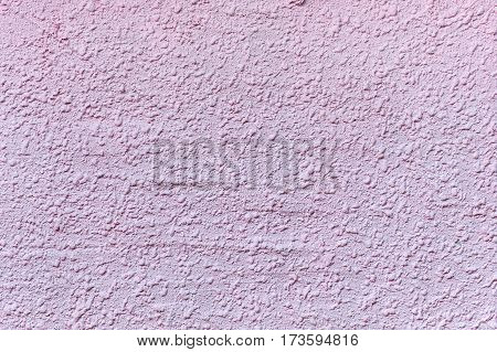 Relief plastered surface in muddy pinkish color. For background and texture.