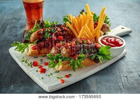 Cumberland sausage hot dogs with caramelized onion, roasted red peppers, french fries and beer.