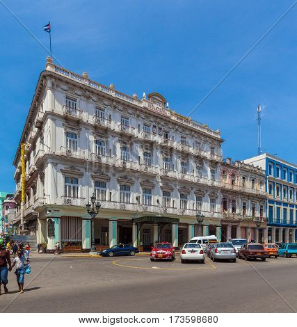 Havana, Cuba - April 1, 2012: Cubans Walk The Streets Of The Town Near Hotel Inglaterra
