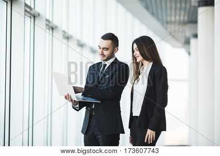 Couple discussing new project on the laptop. Teamwork concepts.