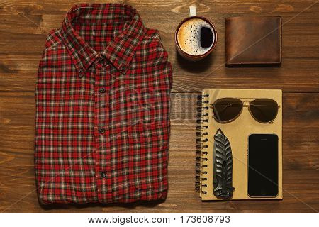 Something for outdoors adventure in retro style - chekered shirt scetchbook cell phone jackknife wallet and sunglasses