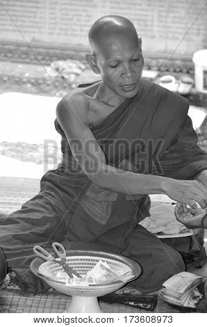 PHNOM KULEN CAMBODIA MARCH 27: Monk in Wat Preah Ang Thom on march 27 2013 in Phnom Kulen Camodia. Buddhism is the faith of 96% of Cambodians.