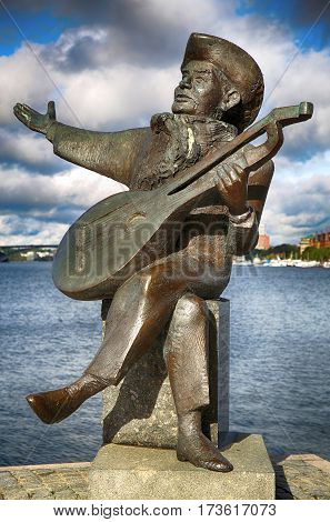 STOCKHOLM SWEDEN - AUGUST 19 2016: View of Evert Taube monument with guitar on Gamla stan in Stockholm Sweden in Stockholm Sweden on August 19 2016.