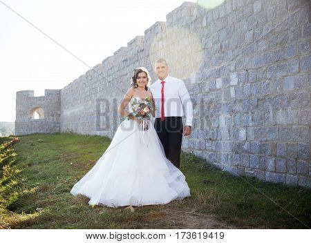 Beautiful young couple. the bride and groom on their wedding day. Are the lengthwise walls