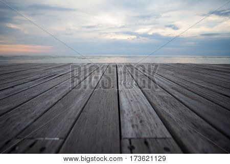 Closeup of old wooden floors and a tropical beach at sunset