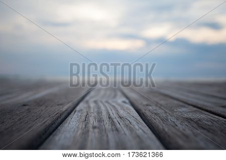 Closeup of old wooden floors and a tropical beach at sunset