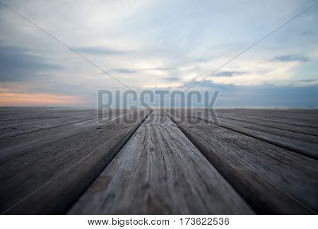 Closeup of old wooden floors and a tropical beach at sunset