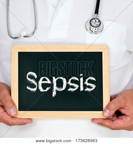 Sepsis - Doctor holding chalkboard with text in his hands