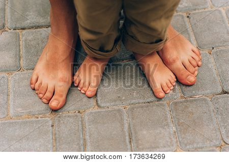 feet of child and mom in the sea sand. legs feet mom and son