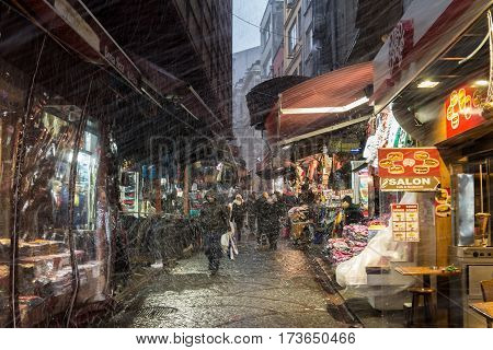 ISTANBUL TURKEY - DECEMBER 30 2015: Snow storm hitting a typical Istanbul street near the Spice market