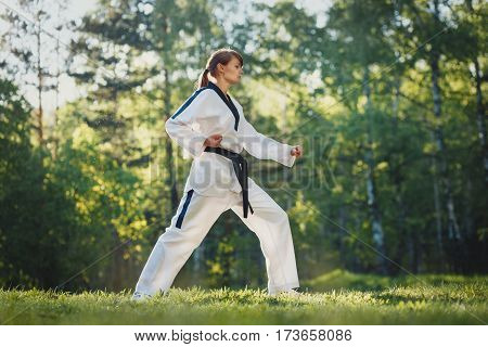 A shot of an woman practicing karate