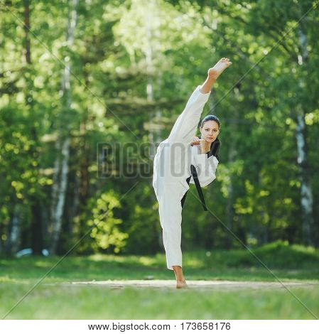 A shot of an woman practicing karate