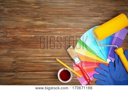 Composition of decorator and house renovation tools on wooden table