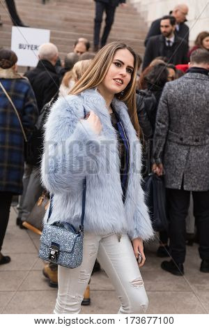 MILAN ITALY - FEBRUARY 23: Fashionable woman poses outside Genny fashion show during Milan Women's Fashion Week on FEBRUARY 23 2017 in Milan.