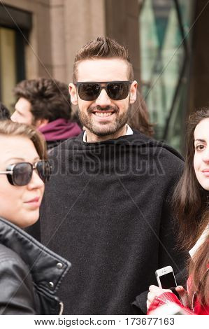 MILAN ITALY - FEBRUARY 23: Fashionable man poses outside Genny fashion show during Milan Women's Fashion Week on FEBRUARY 23 2017 in Milan.