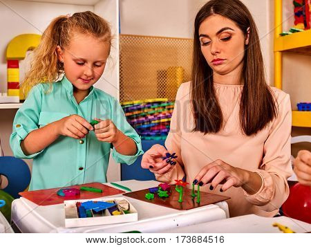 Plasticine modeling clay. Child dough play in school mold from plasticine in kindergarten .Kids knead modeling clay with hands in preschool.