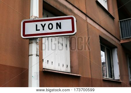 Lyon - a city in France. Road sign on the background of the old house with wooden shutters.