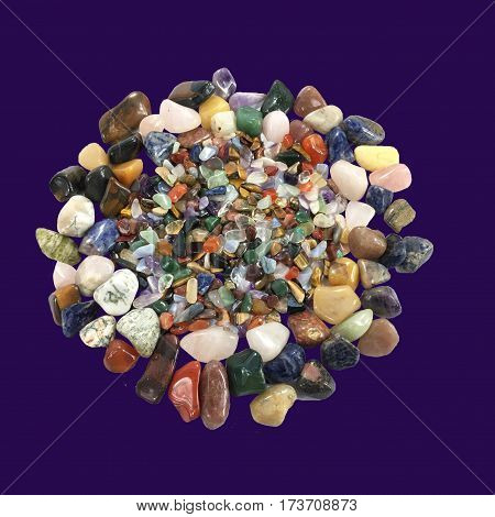 Beautiful background with colorful various gemstone on purple background.