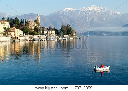 People On A Rowing Boat At The Coast Of Lake Como