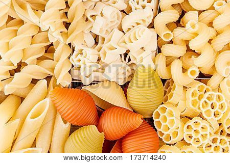 Pasta background assortment of different kinds italian macaroni in chess cells top view. Healthy traditional food backdrop.